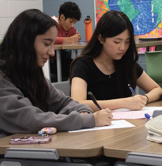 A-CUTE CLUB: Freshmen Alina Noman (left), Natalie Choi (right) and Vince Pallikunnel (back) work dilligently on a Thursday afternoon. The freshman team were completing worksheets to sharpen their skills. 